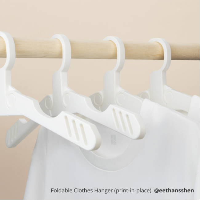 PLA TOUGH+ Foldable clothes hanger on a wooden rod with beige background