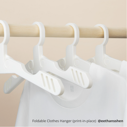PLA TOUGH+ Foldable clothes hanger on a wooden rod with beige background